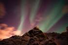 An aurora borealis behind a mountain peak in Andenes Andenes-Vesteralen Islands-Nordland-Norway Art Print